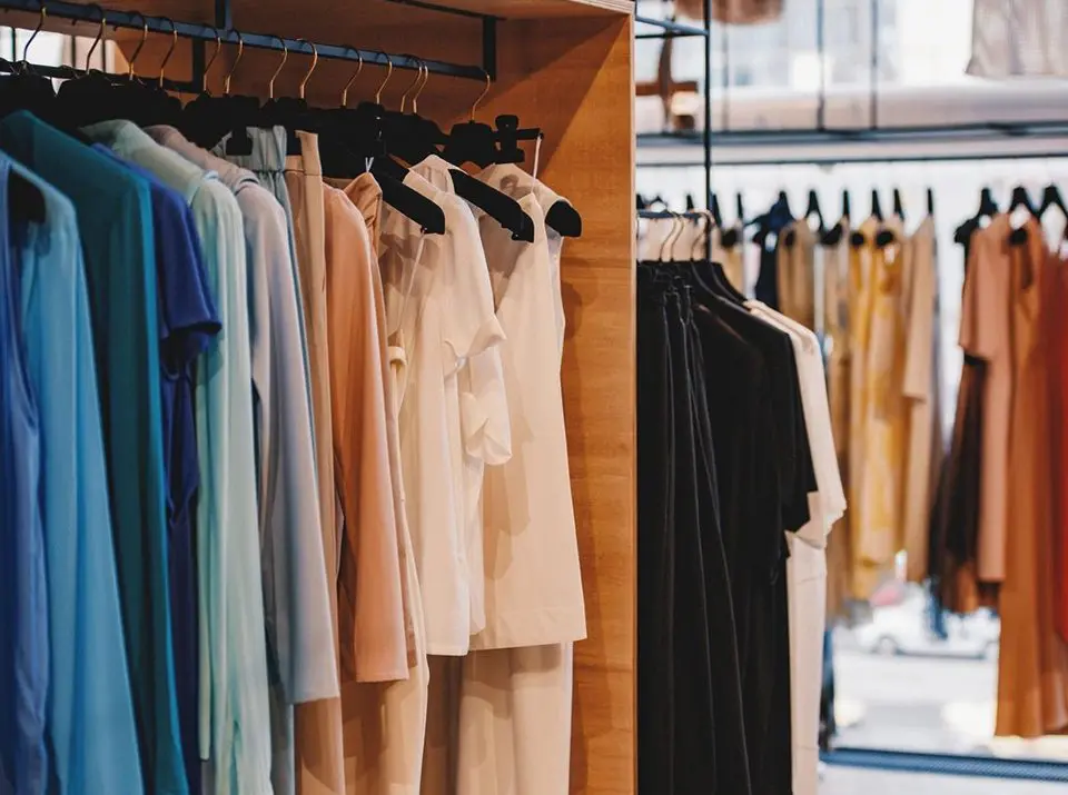 Colorful clothes on racks in a fashion boutique